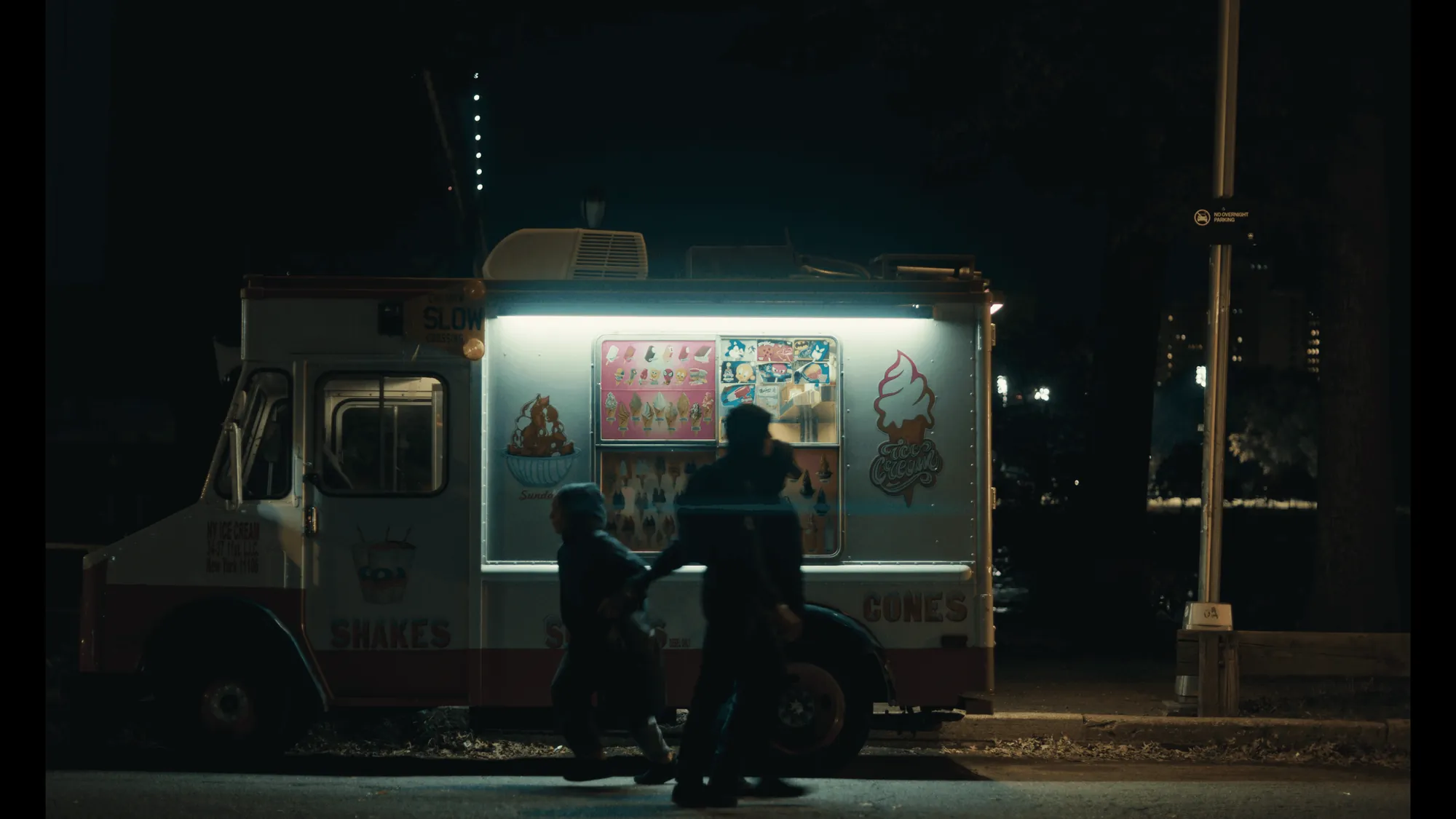 An ice cream truck glowing on a dark street, from Prosperous Pairs